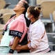 Zheng Qinwen is attended to after experiencing menstrual cramps during the Women’s Singles Fourth Round match against Iga Swiatek